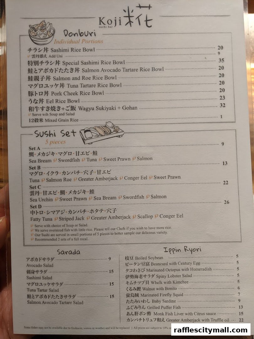 A menu from Koji Sushi Bar featuring Donburi, Sushi Sets, Sarada, and Ippin Ryori dishes.