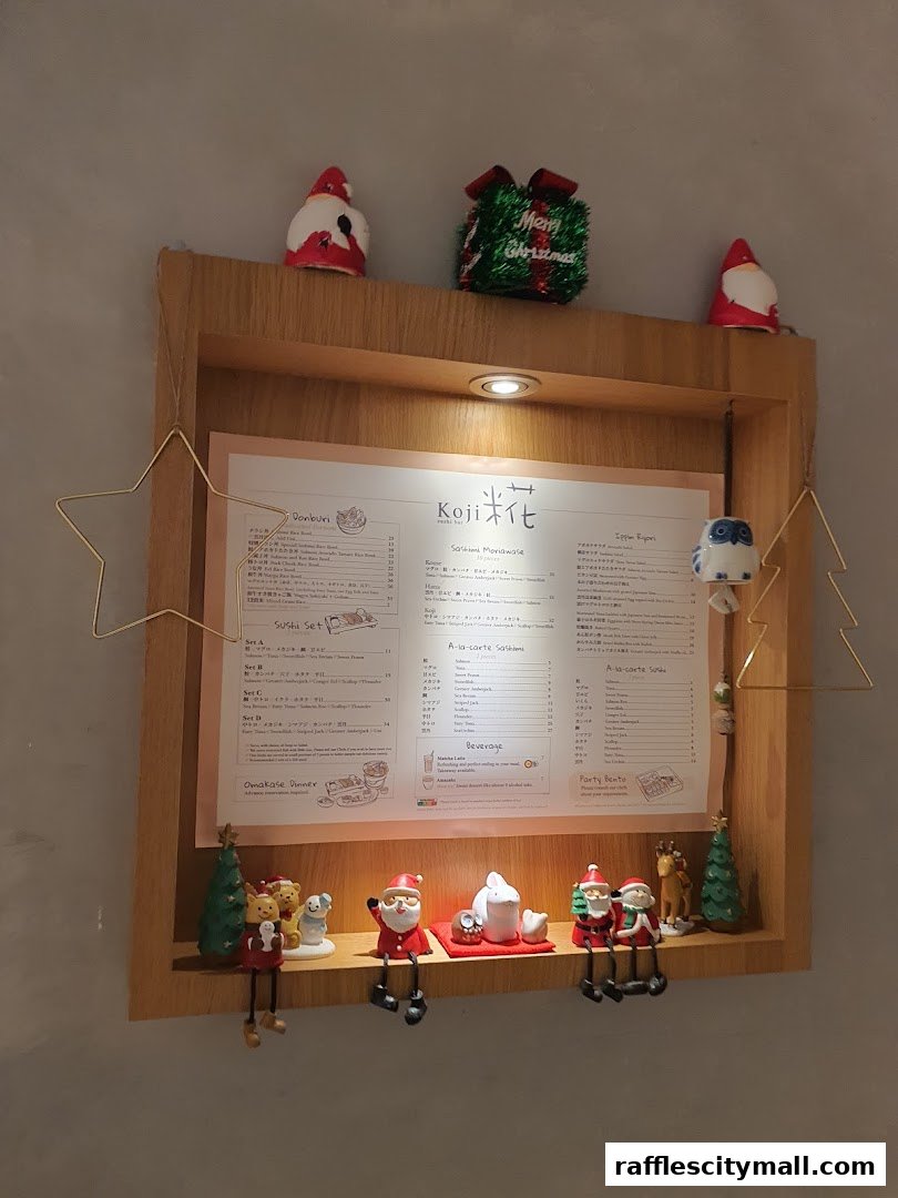 A menu board for Koji Sushi Bar with Christmas decorations.