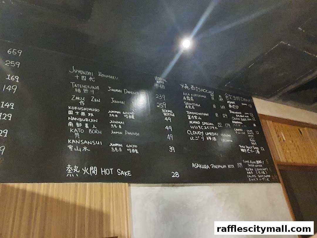 A chalkboard menu displaying various Japanese sake and shochu with prices.