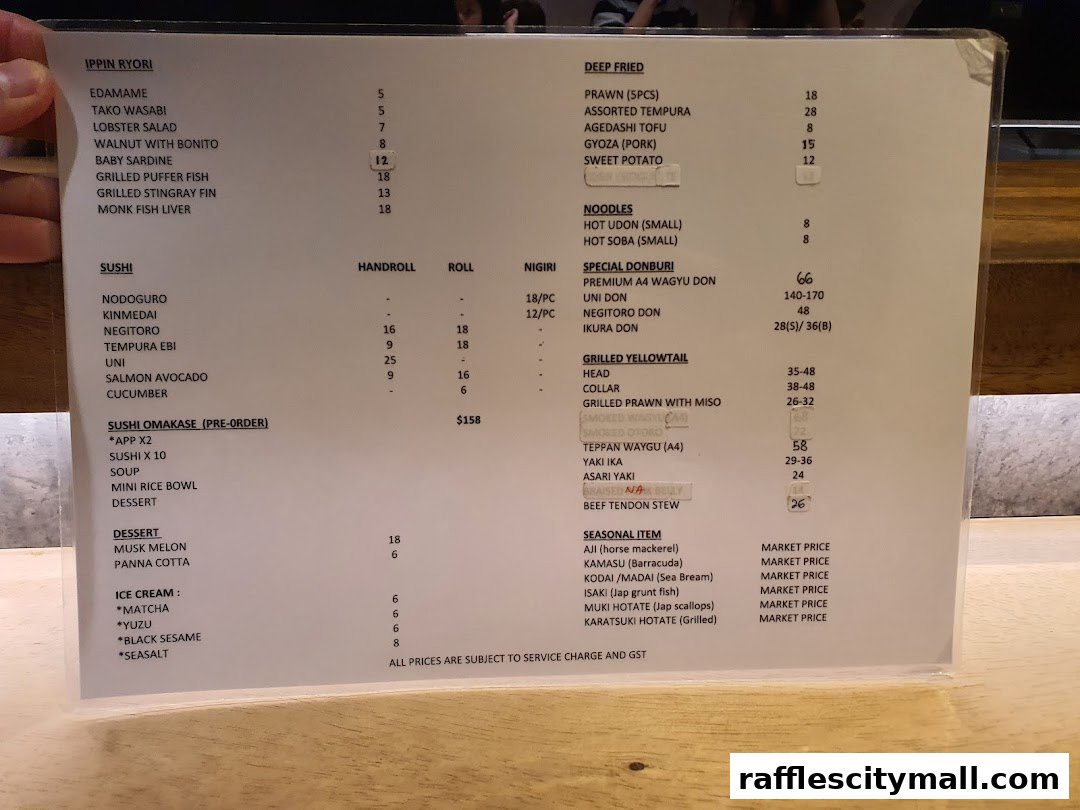 A menu from Koji Sushi Bar with various Japanese dishes and prices.