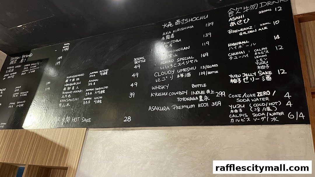 A chalk menu board displaying various Japanese drinks, including sake, shochu, whisky, and cocktails.