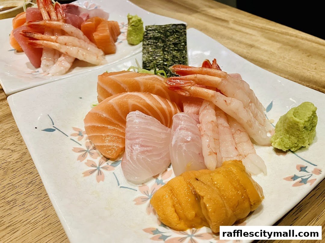 Plates of fresh sashimi, including salmon, shrimp, and uni, served with wasabi and nori.