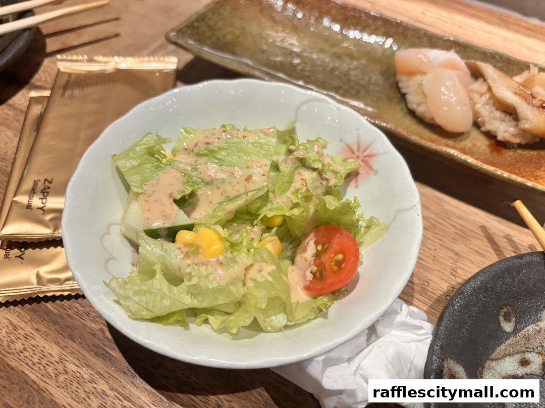 A fresh salad with dressing and corn, served with sushi in the background.