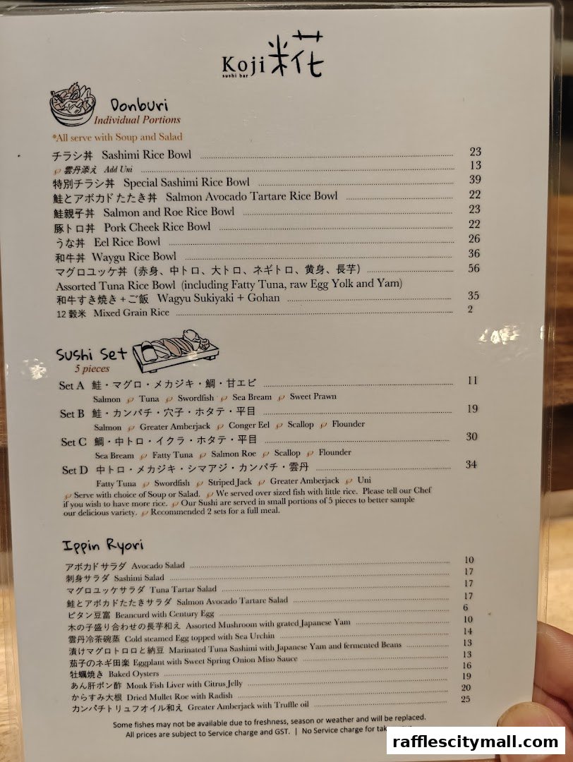 A menu from Koji Sushi Bar featuring Donburi, Sushi Sets, and Ippin Ryori dishes.