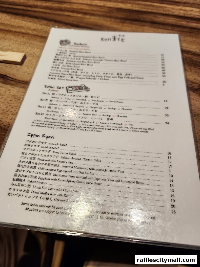 A menu from Koji Sushi Bar with various sushi sets and Japanese dishes.