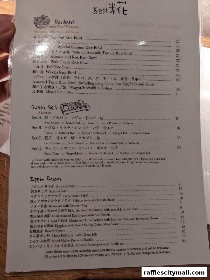 A menu from Koji Sushi Bar featuring Donburi, Sushi Sets, and Ippin Ryori dishes.