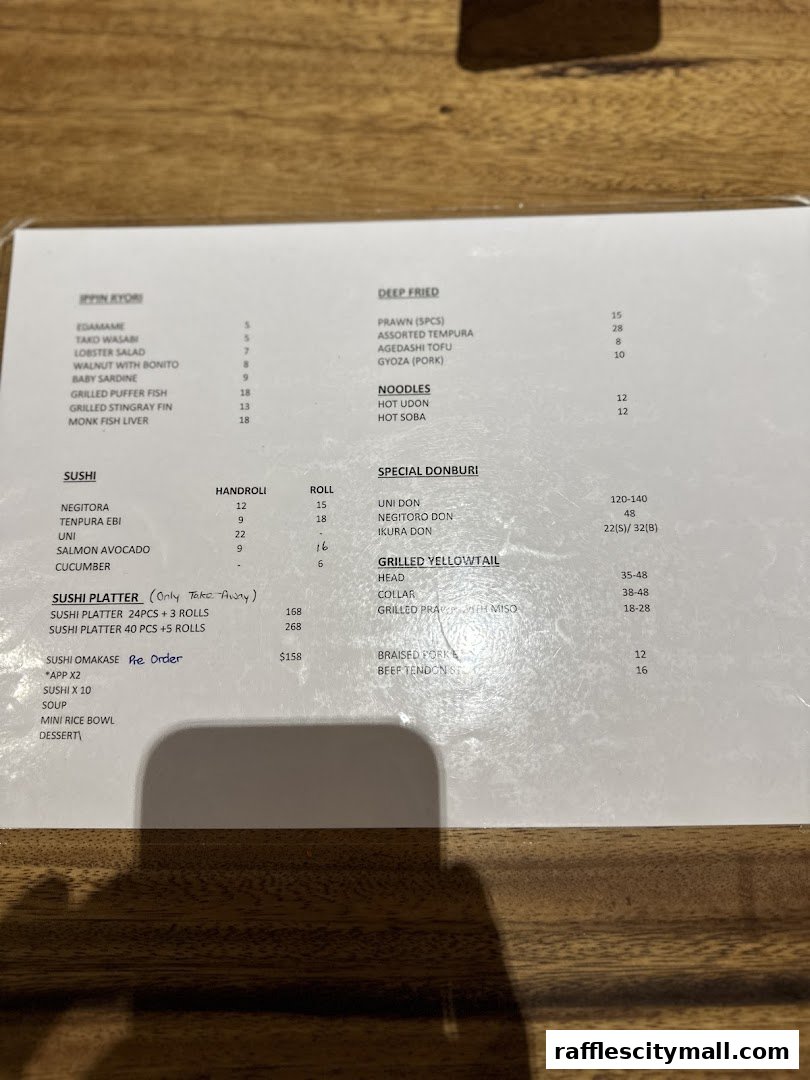 A menu from Koji Sushi Bar with various sushi, deep-fried items, noodles, and donburi options.