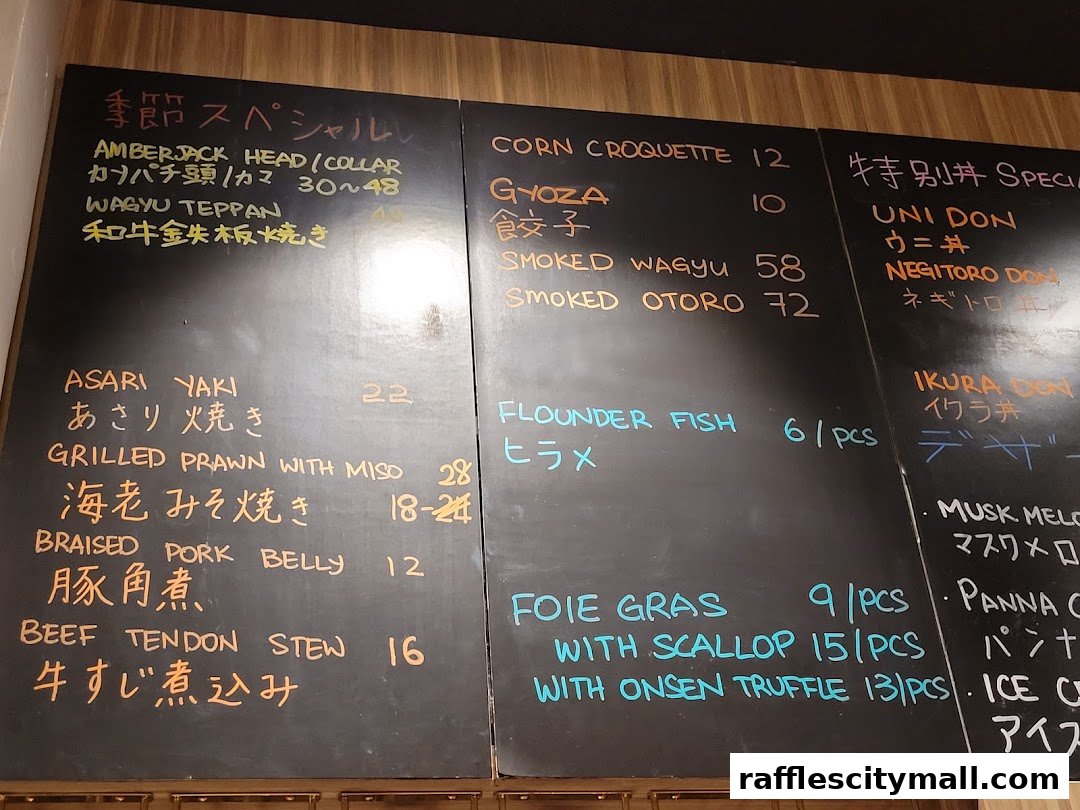 A chalk menu board with various Japanese dishes and prices listed.
