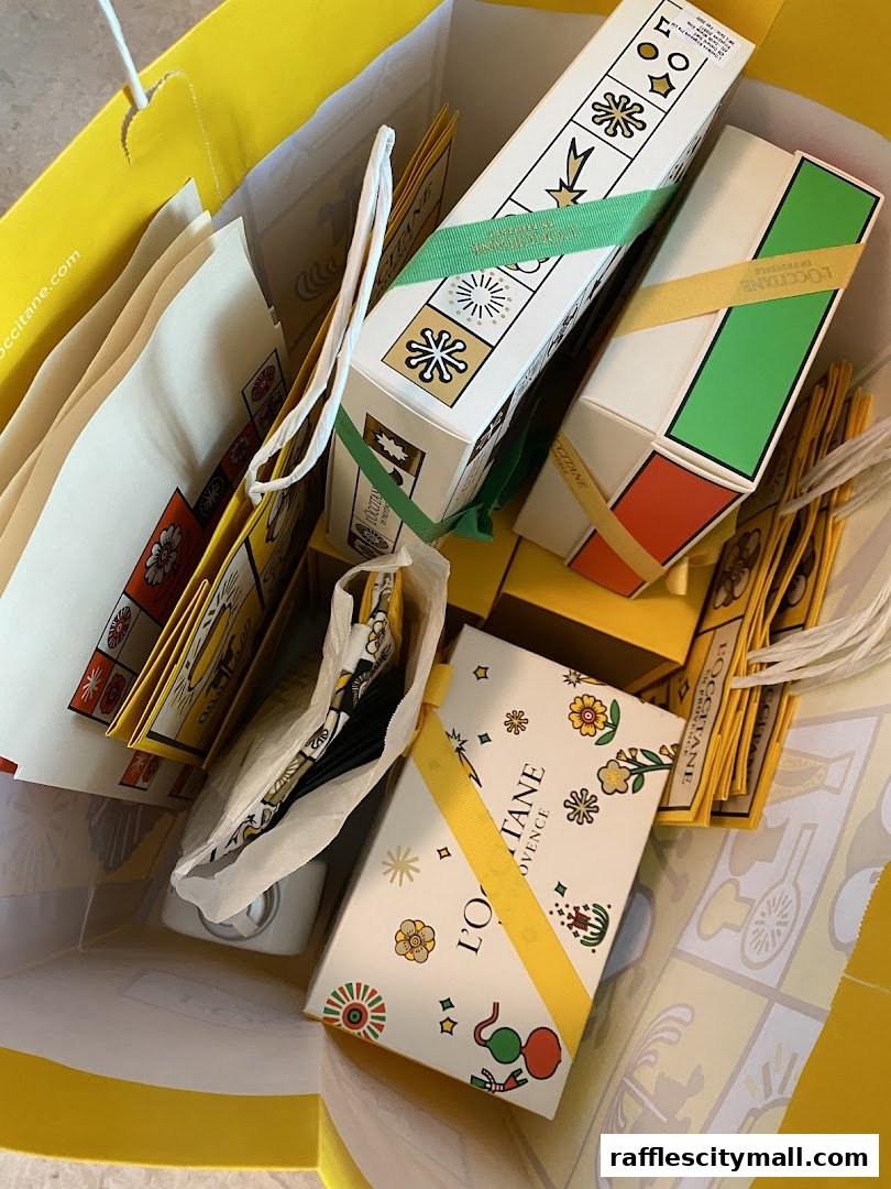 A bright yellow shopping bag filled with L'Occitane products and packaging.
