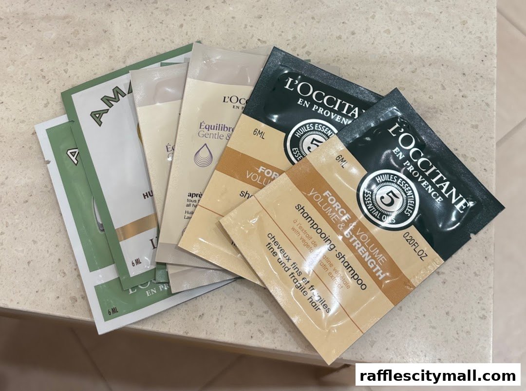 A collection of L'Occitane sample sachets, including shampoo and conditioner.