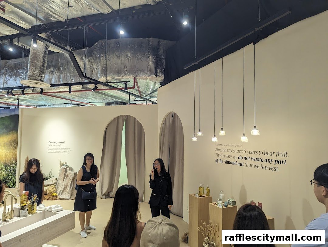 People are gathered inside a L'Occitane store, listening to a presentation about almonds.