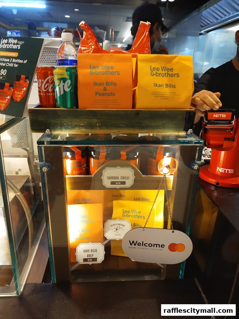 A display of Lee Wee & Brothers products including Sambal Chilli, Ikan Bilis, and Ikan Bilis & Peanuts.