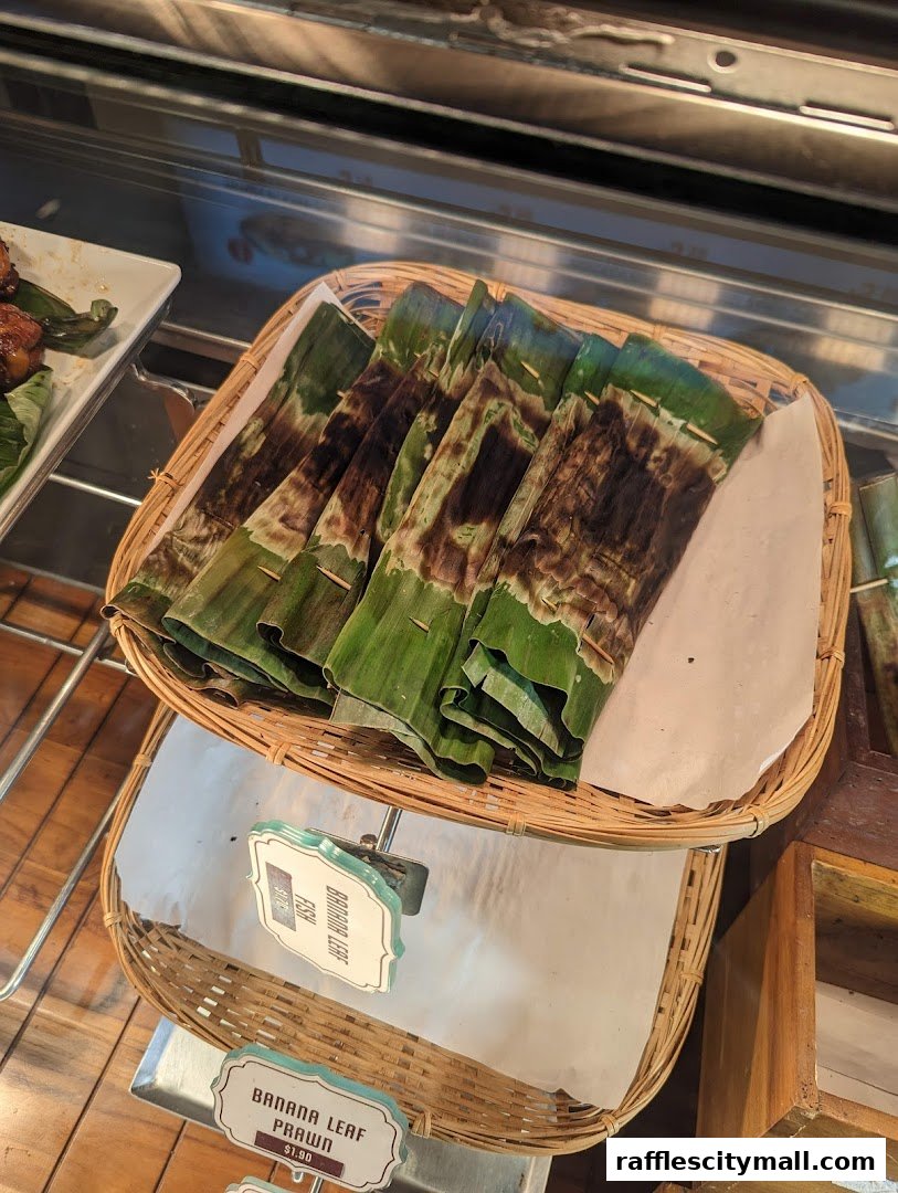 A close-up of grilled seafood wrapped in banana leaves, presented in a woven basket.