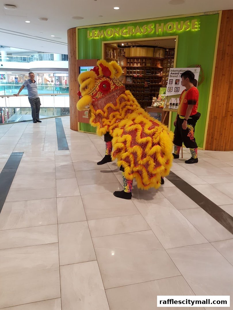 Lion dance performance in front of Lemongrass House shop with people watching.