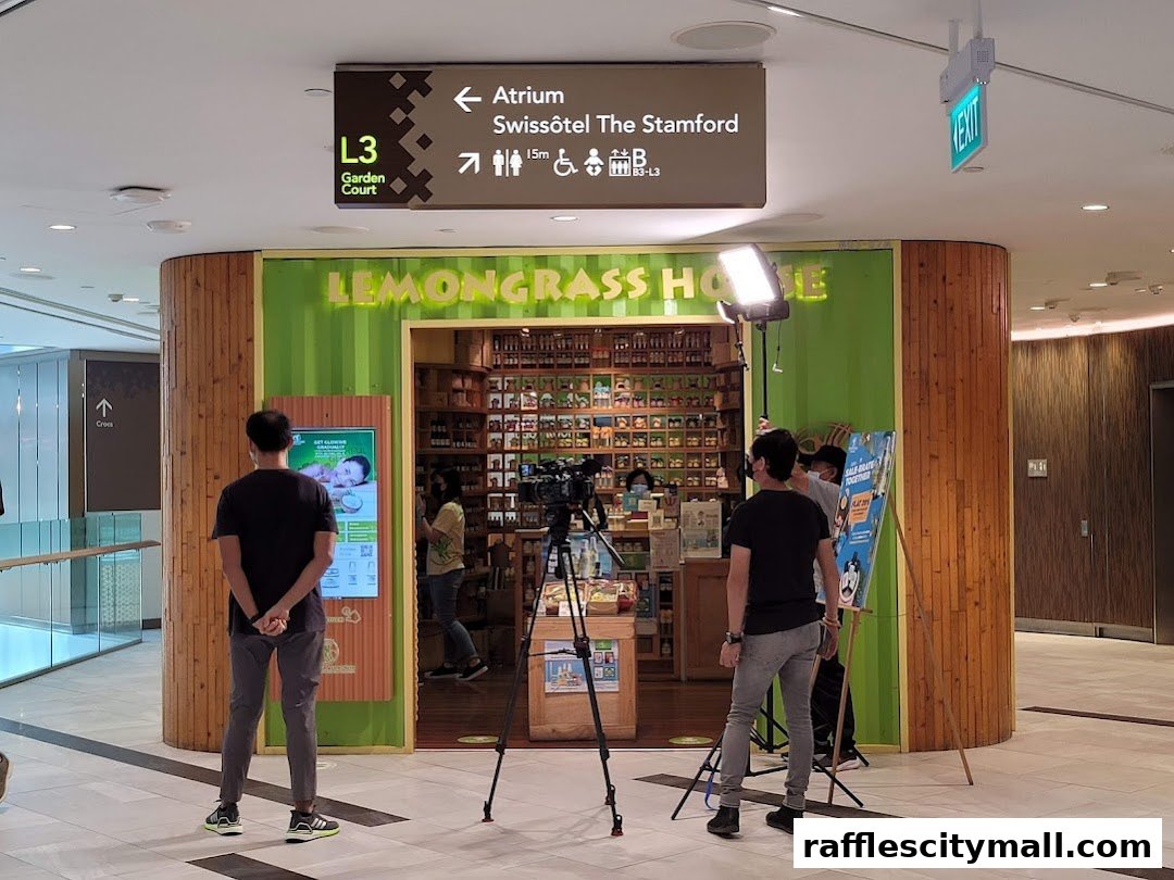 The Lemongrass House shop entrance with people and filming equipment.