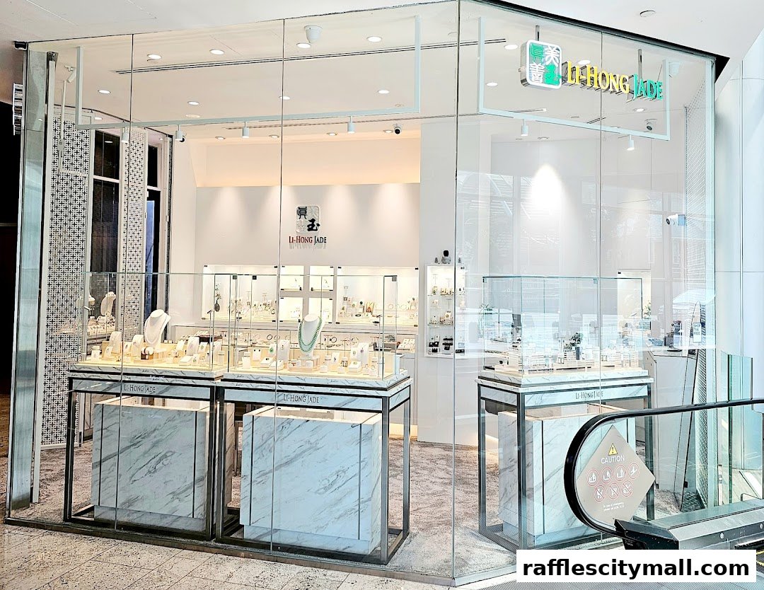 The exterior of a modern jewelry store, LI-HONG JADE, showcasing display cases filled with jewelry.