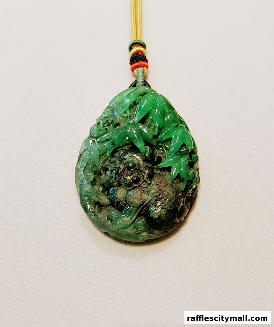 A detailed jade pendant featuring a mythical creature amidst bamboo leaves.