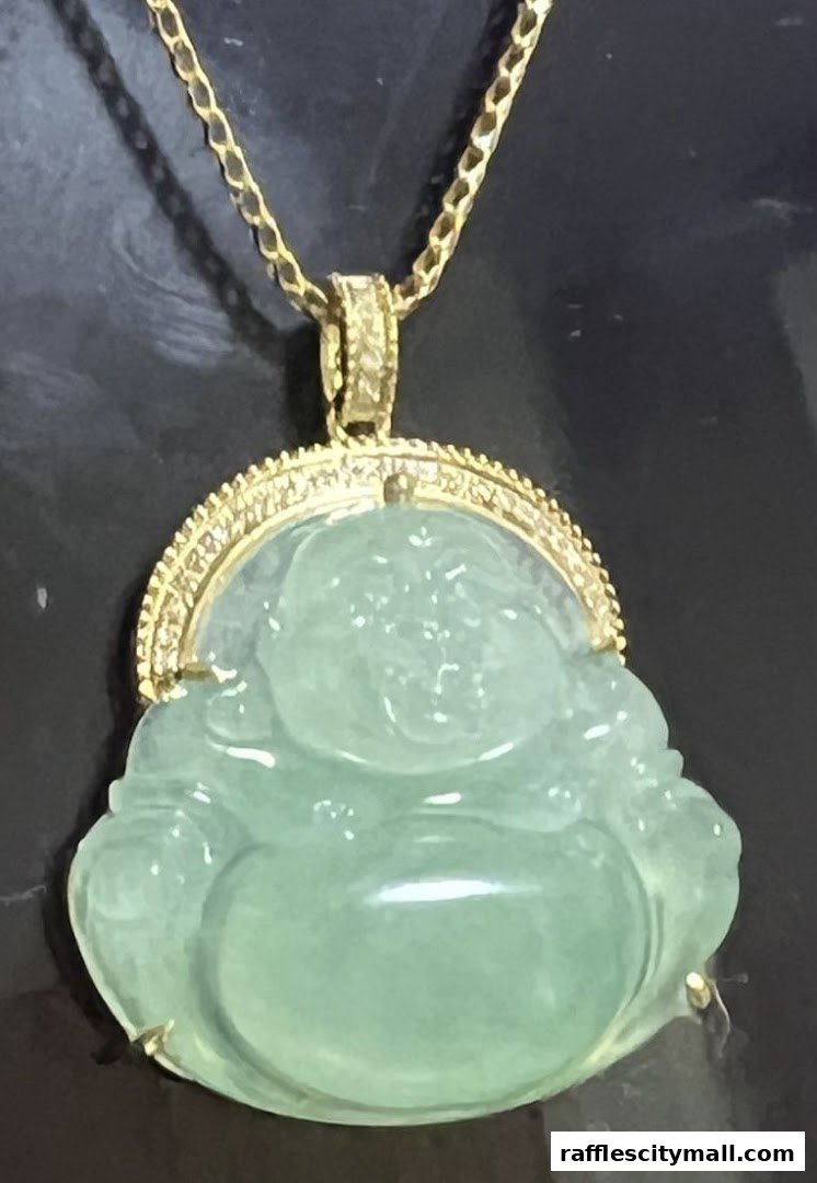A close-up of a jade pendant shaped like a laughing Buddha, set in gold.