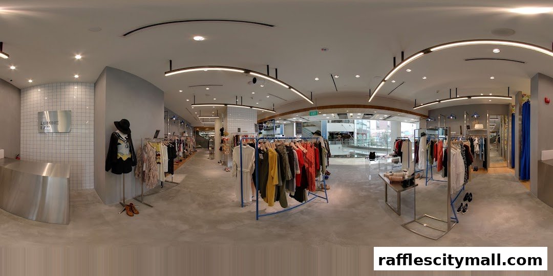 Interior view of a modern clothing boutique with racks of apparel and a reception desk.