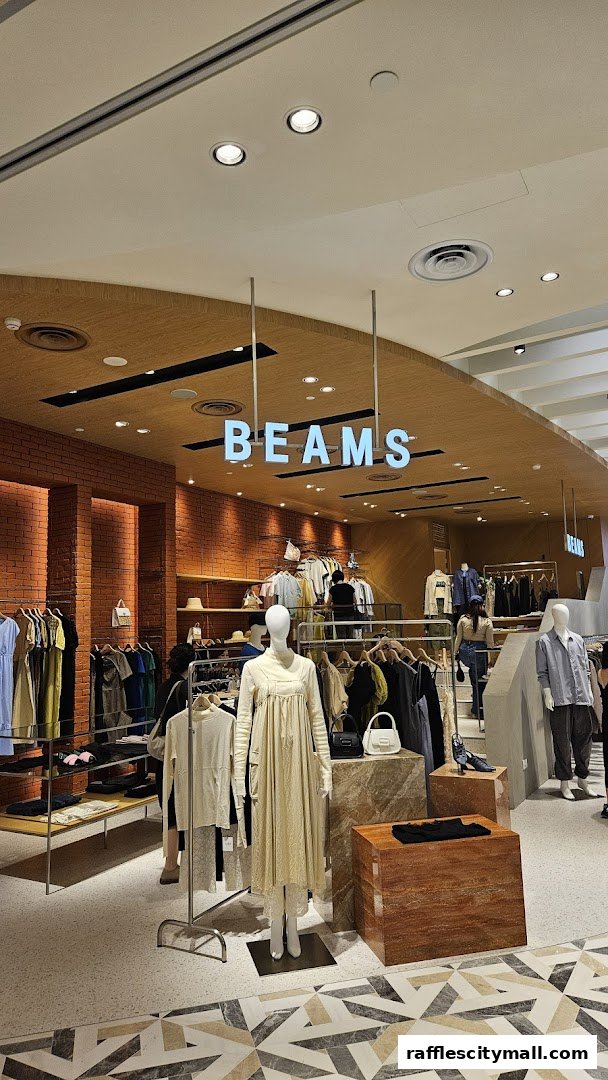 Interior view of a BEAMS clothing store with mannequins and apparel on display.