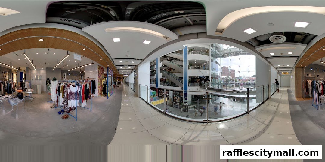 Interior view of a modern retail store with clothing displays and a view of the mall atrium.