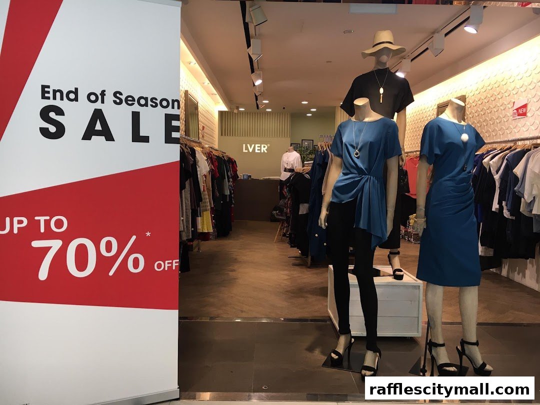 Shop front with mannequins displaying clothing and an 'End of Season Sale' banner.