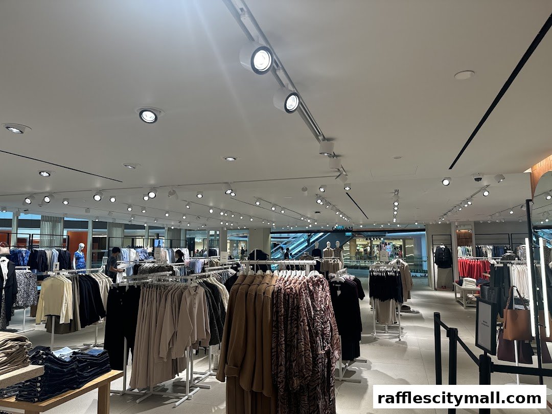 Interior view of a brightly lit MANGO clothing store with racks of apparel and mannequins.