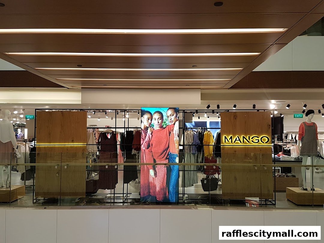 The MANGO store entrance features a digital display with models and clothing racks visible inside.