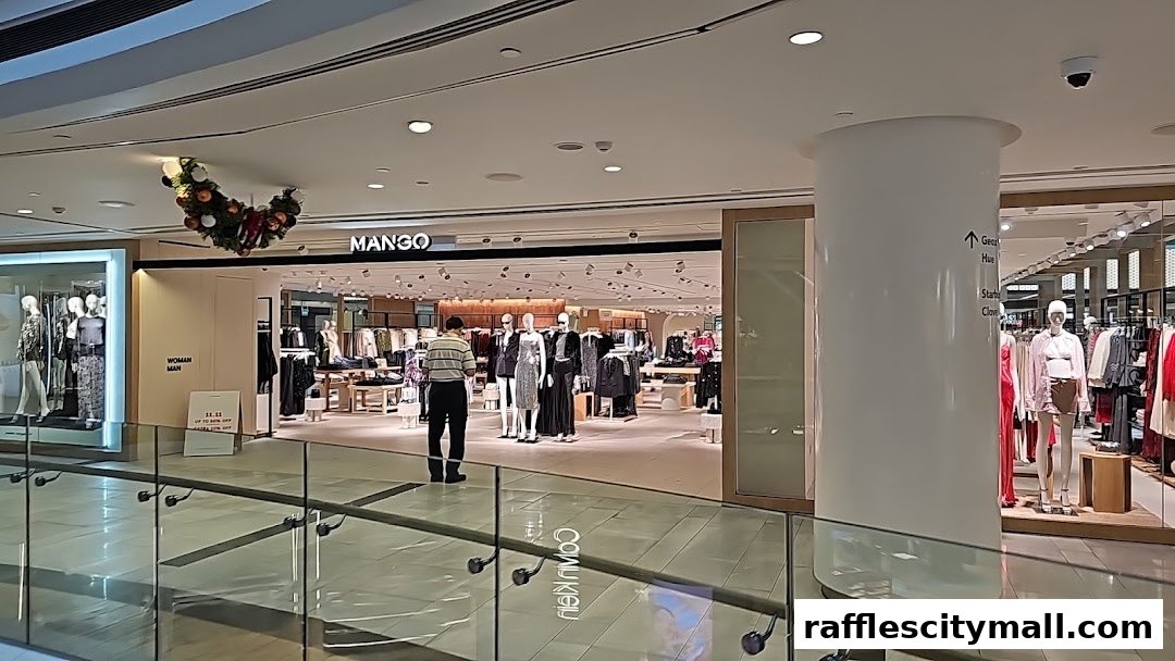 The MANGO store entrance with mannequins displaying fashion and a festive wreath overhead.