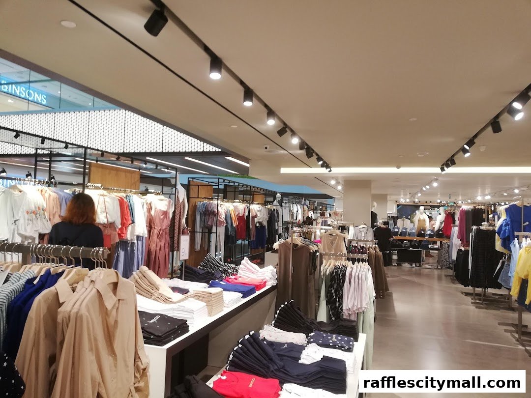 Interior view of a MANGO clothing store with racks of apparel and displays.
