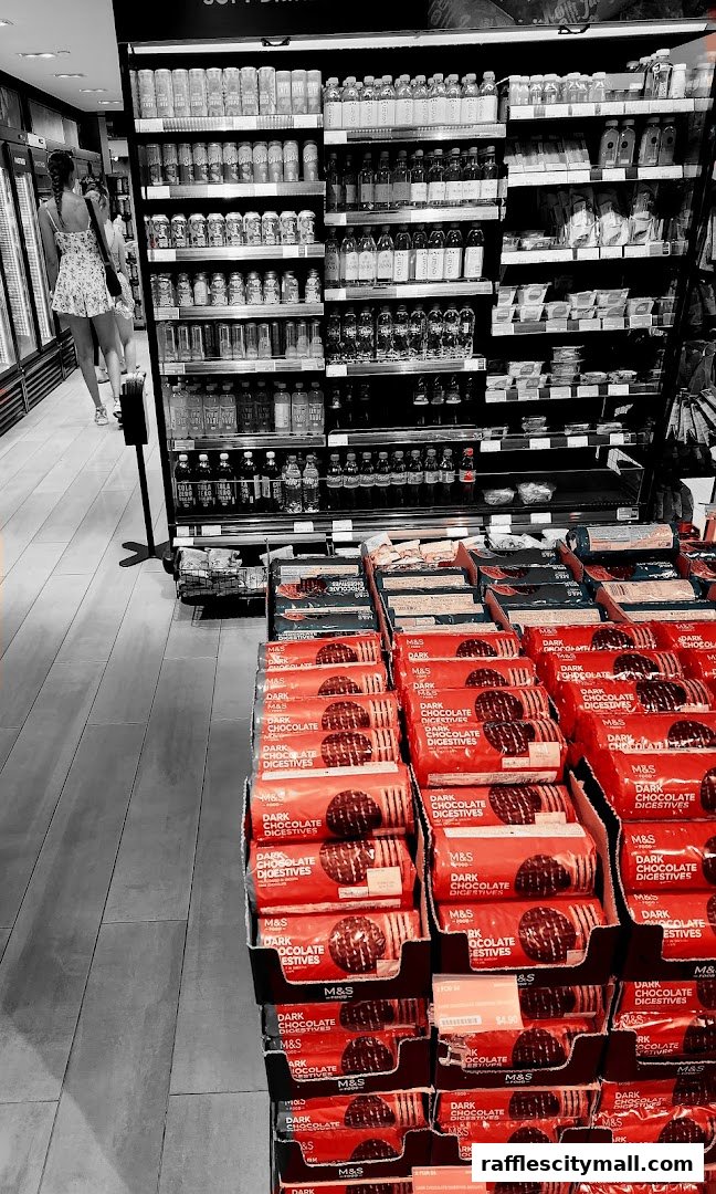 A display of M&S Dark Chocolate Digestives and various beverages in a retail store.