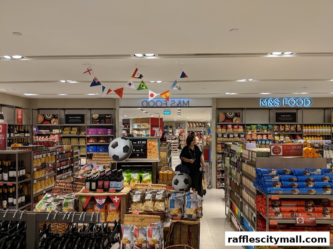 Interior of a Marks & Spencer food store with aisles of groceries and promotional displays.