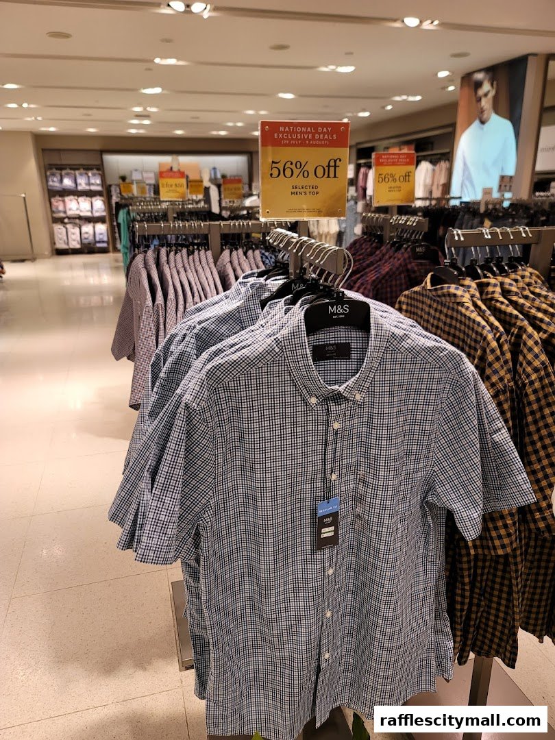 A display of men's shirts with a 56% off sale sign at Marks & Spencer.