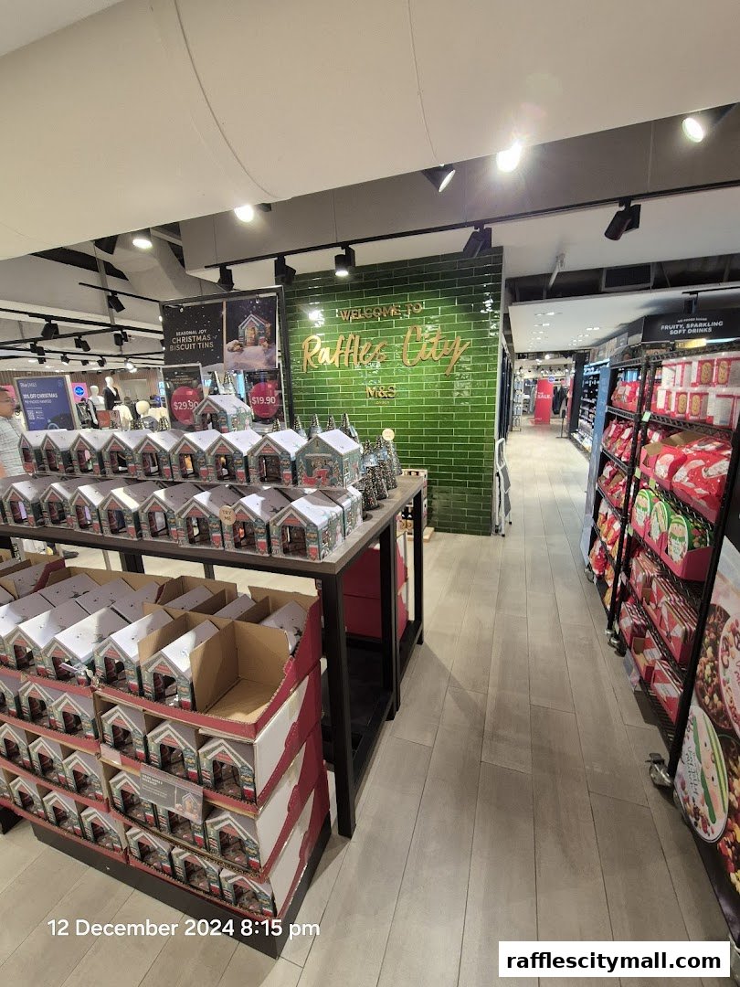 Interior view of a Marks & Spencer store with Christmas biscuit tins and drinks on display.