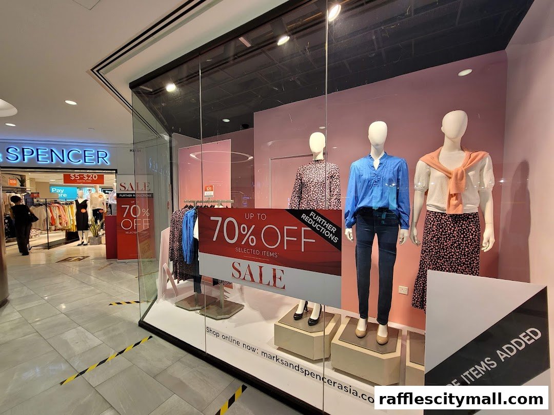 Marks & Spencer shop front with mannequins displaying sale items and a large '70% OFF' sign.