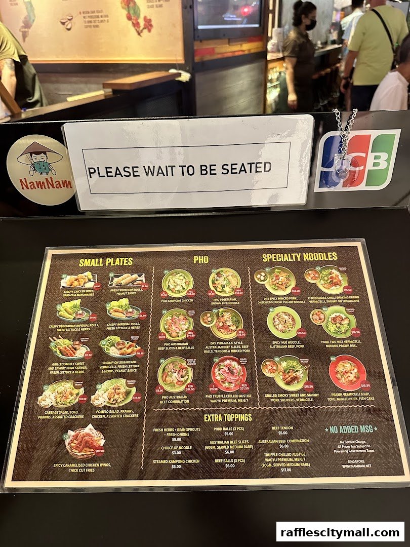 A menu from NamNam Raffles City featuring small plates, pho, and specialty noodles.