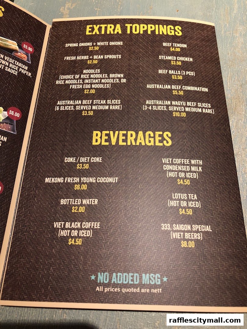 A menu from NamNam Raffles City featuring extra toppings and beverages.