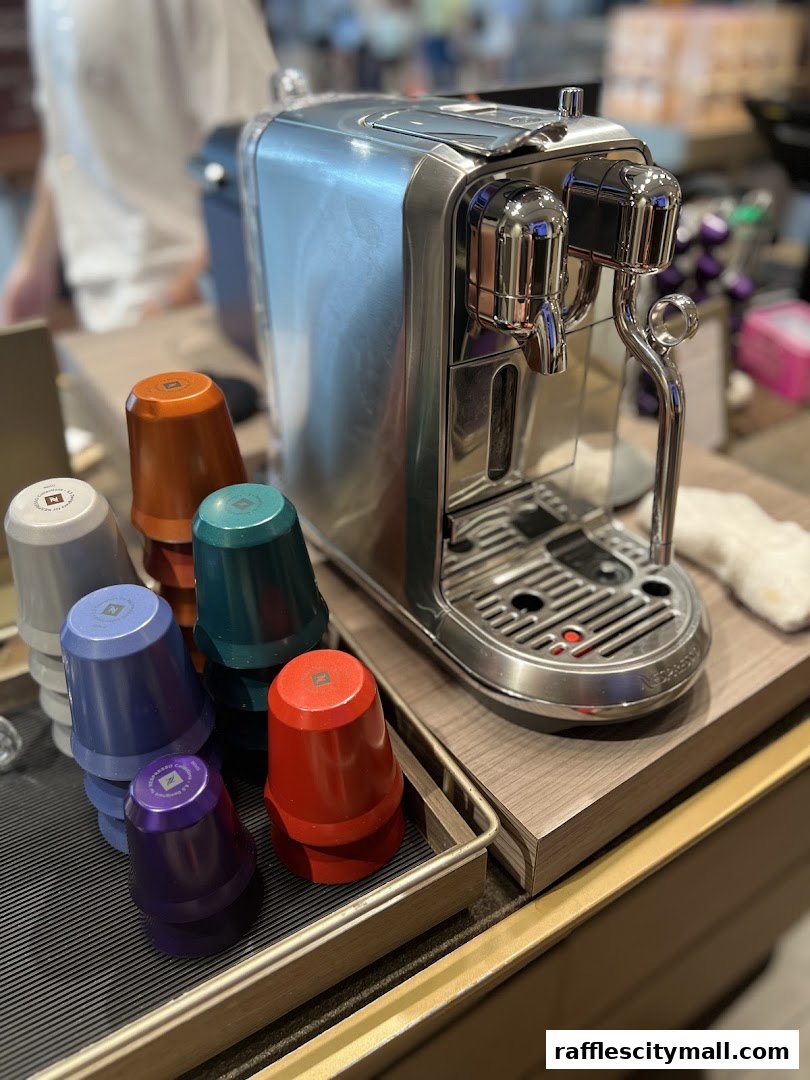 A Nespresso coffee machine with colorful coffee capsules displayed on a counter.