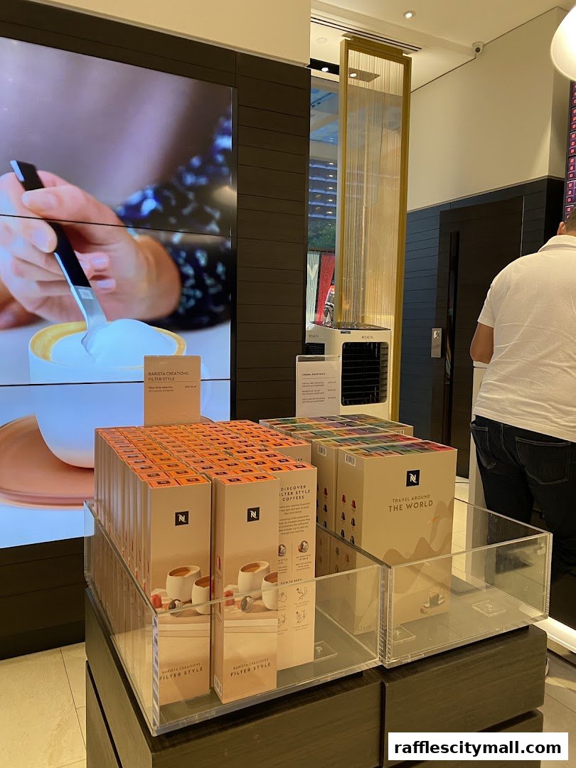 Nespresso boutique interior showcasing coffee capsule displays and a promotional video.