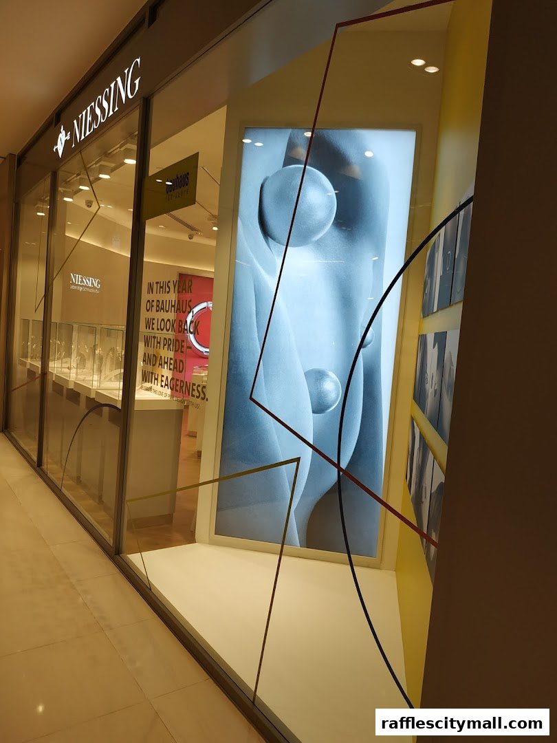 The exterior of the Niessing jewelry store, showcasing its modern window display and branding.
