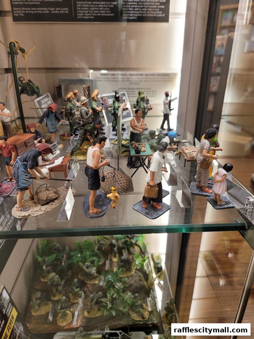 A display case filled with miniature figurines depicting historical Singaporean scenes and soldiers.