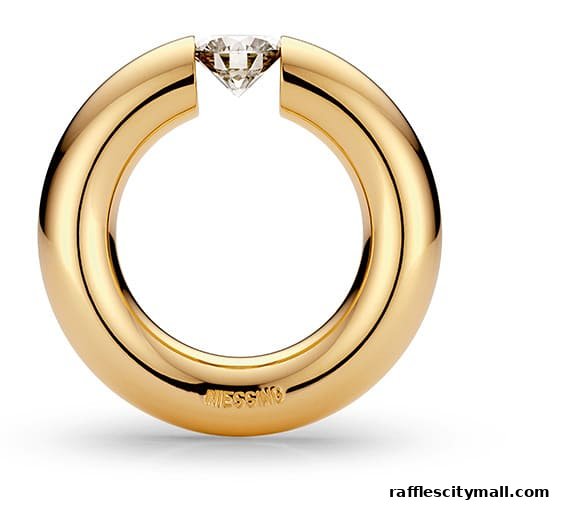 A close-up of a gold ring with a diamond set in its opening.