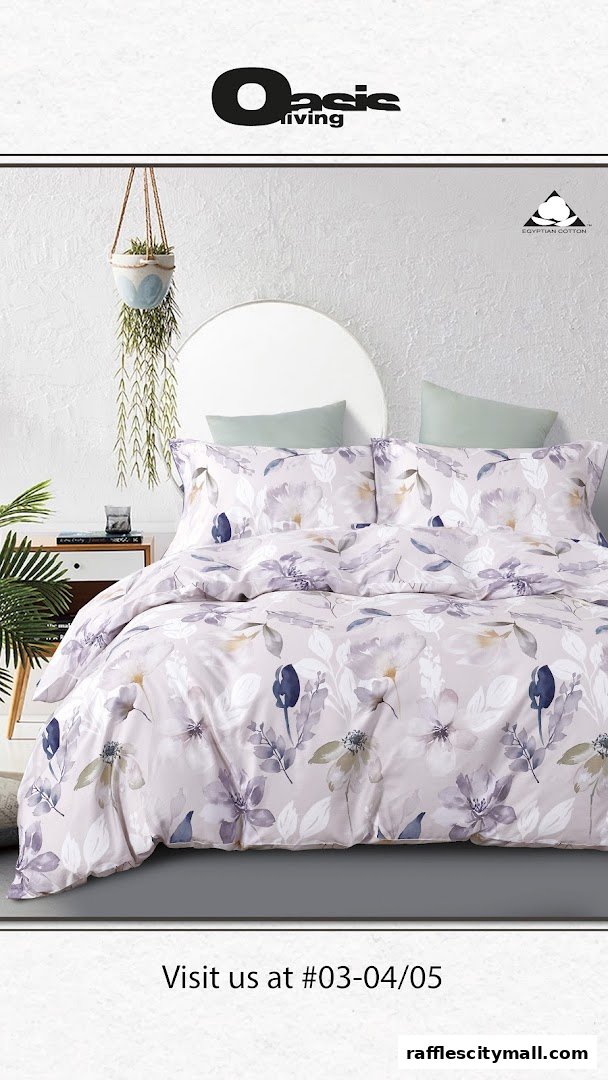 A beautifully made bed with floral patterned duvet and pillows, featuring Oasis Living branding.