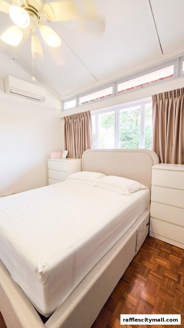 A bright bedroom with a bed, dresser, air conditioner, and ceiling fan.
