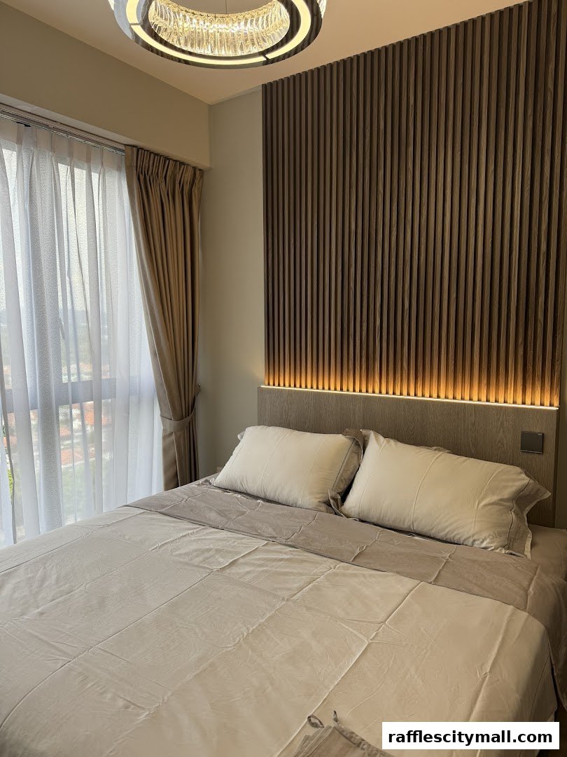 A beautifully made bed with plush pillows and a modern, textured headboard.