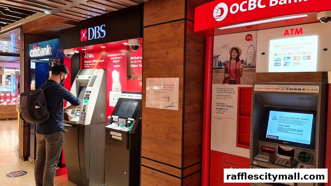 A person uses a DBS ATM next to an OCBC Bank ATM with various payment card logos displayed.