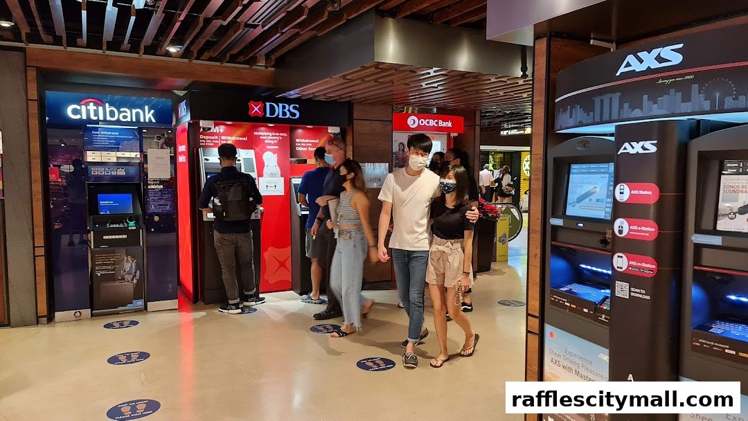 People queue at ATMs for Citibank, DBS, OCBC Bank, and AXS machines in a mall.