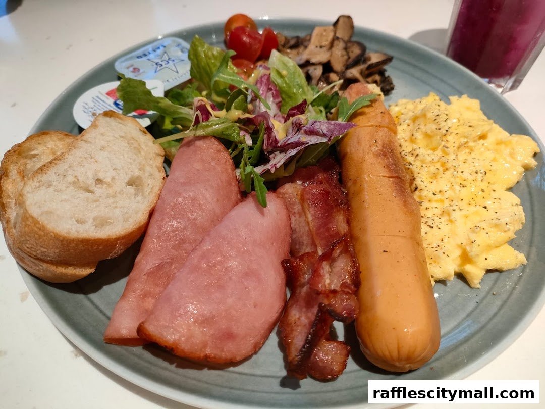 A hearty breakfast platter with scrambled eggs, sausage, bacon, ham, bread, and salad.