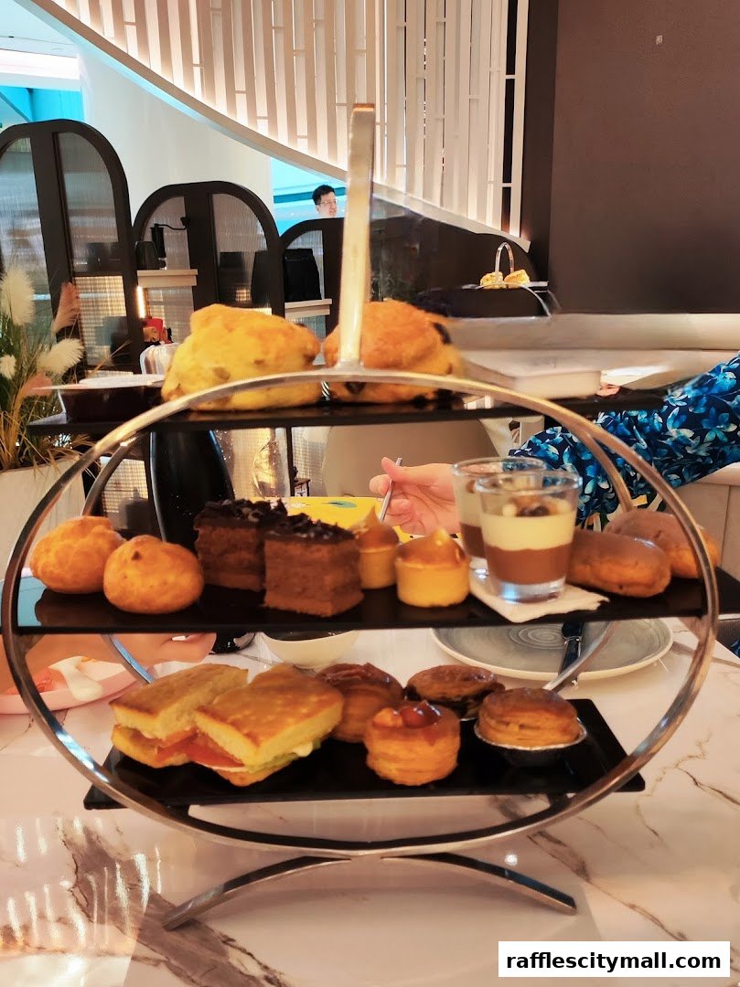 A tiered stand filled with various pastries, sandwiches, and desserts, presented elegantly.