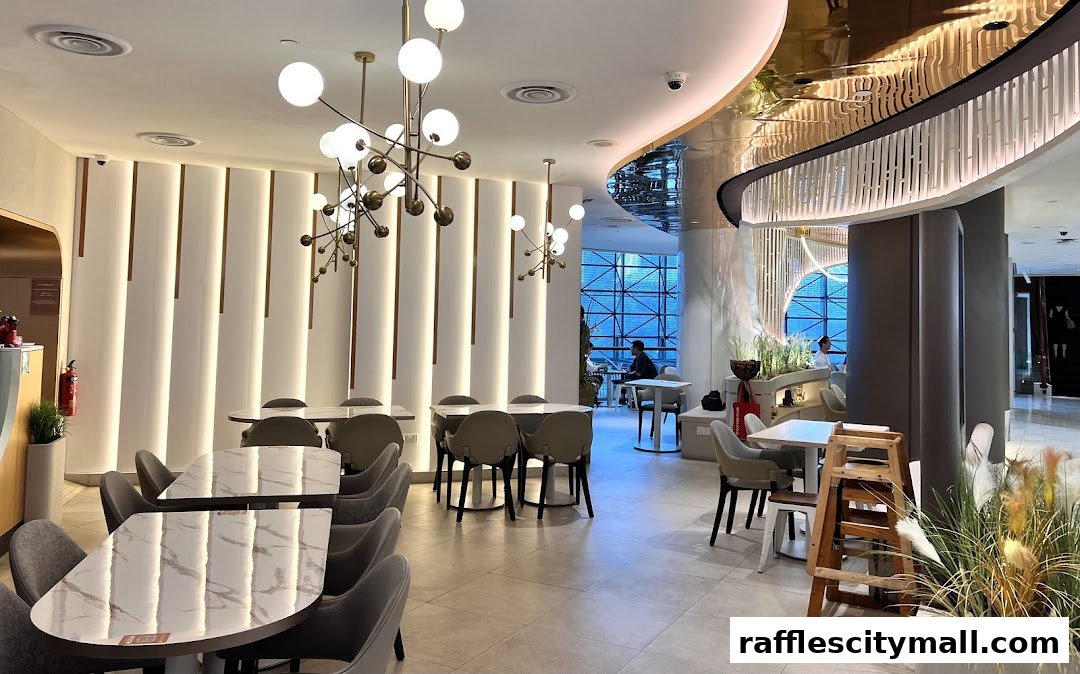 Interior of a modern coffee shop with stylish tables, chairs, and unique lighting fixtures.